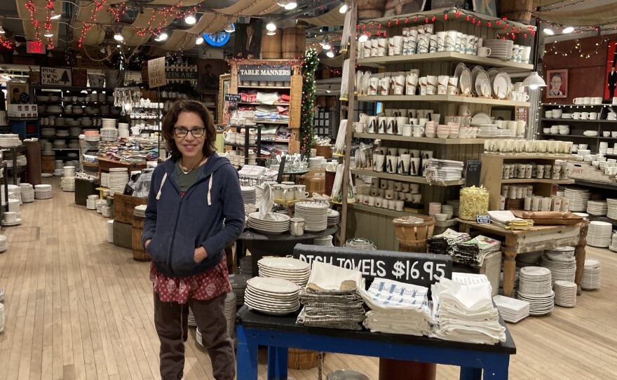 Julie Gaines, owner of New York home goods store Fish's Eddy, poses in front of her collection of cups and plates.