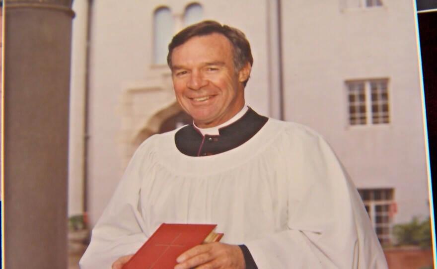 The Rev. James Carroll is shown with a commemorative prayer book gifted to Queen Elizabeth at St. Paul's Episcopal Church on February 27, 1983.