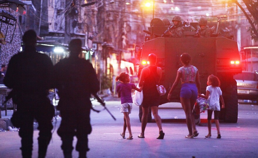 Brazilian navy soldiers in a tank enter Mare on March 30, as part of the government's pacification program to rid the favelas of drug gangs and violence.