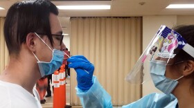 A man getting nasal swapped for a coronavirus test at the Tubman-Chavez Community Center, one of San Diego County's free testing sites, on Nov. 30, 2020.