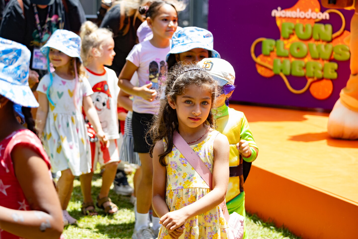 A group of kids join a human train line at the Nickelodeon pop-up at Comic-Con, July 24, 2026. 