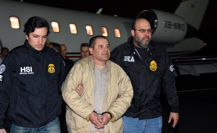 Authorities escort Joaquin "El Chapo" Guzman to a waiting caravan of SUVs at Long Island MacArthur Airport on Thursday in Ronkonkoma, N.Y.
