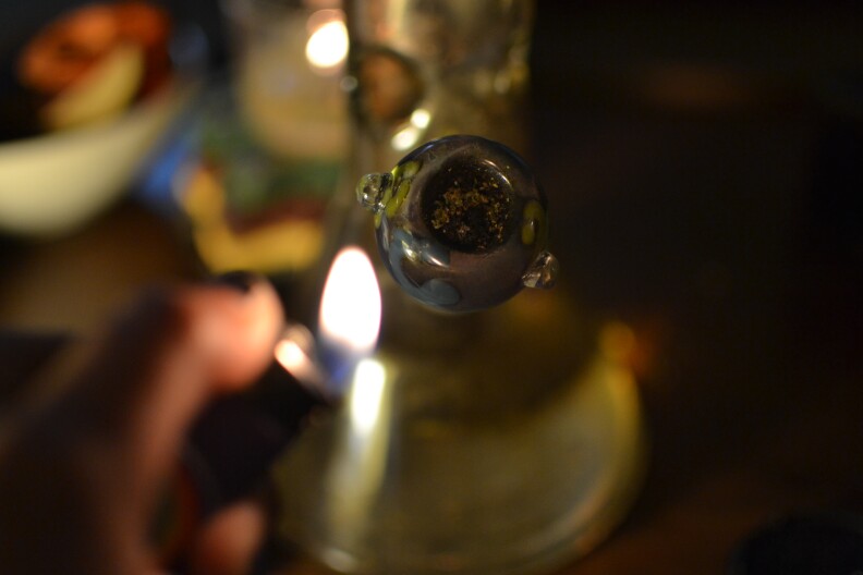 A marijuana user smokes from a bong in this photo, Dec. 9, 2019. 