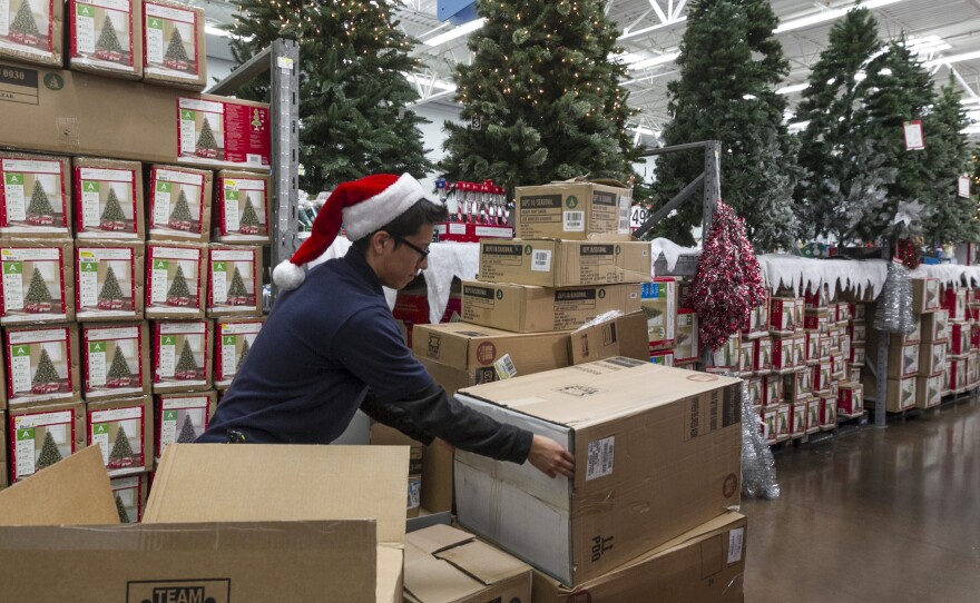 Walmart associate Angel Campos stocks Christmas decorations ahead of a pre-Black Friday event at the Walmart Supercenter store in Rosemead, California, Nov. 22, 2012.