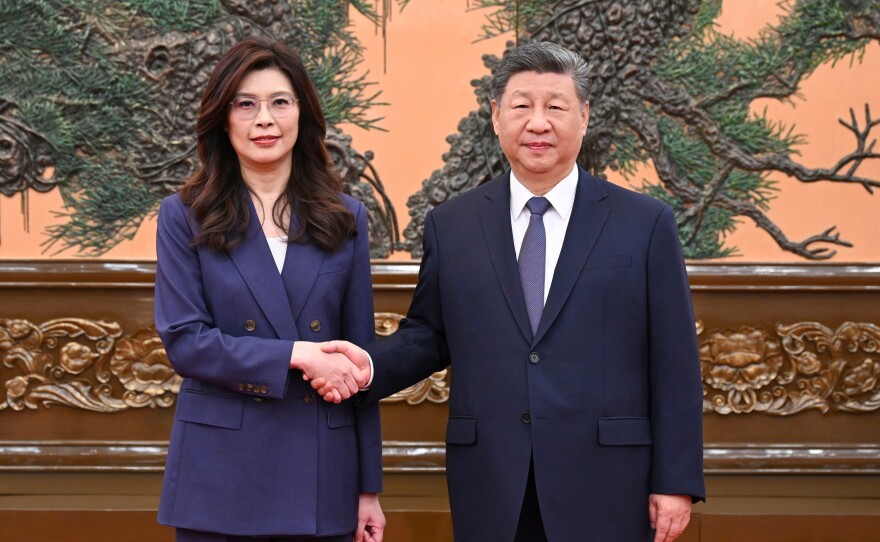 In this photo released by Xinhua News Agency, Chinese President Xi Jinping, right shakes hands with Kuomintang (KMT) party leader Cheng Li-wun in Beijing on Friday, April 10, 2026.