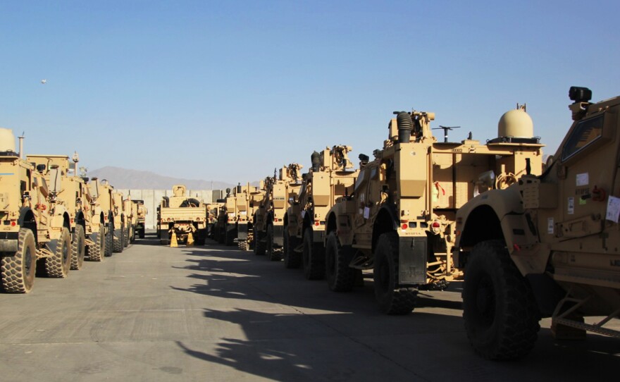 Armored vehicles, known as M-ATVs, are lined up on the tarmac at Bagram Airfield. They will be flown out to the Persian Gulf on cargo planes and then shipped back to the US.