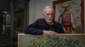 Palestinian artist Sliman Mansour at his home in Jerusalem, surrounded by his paintings on Nov. 18, 2025.
