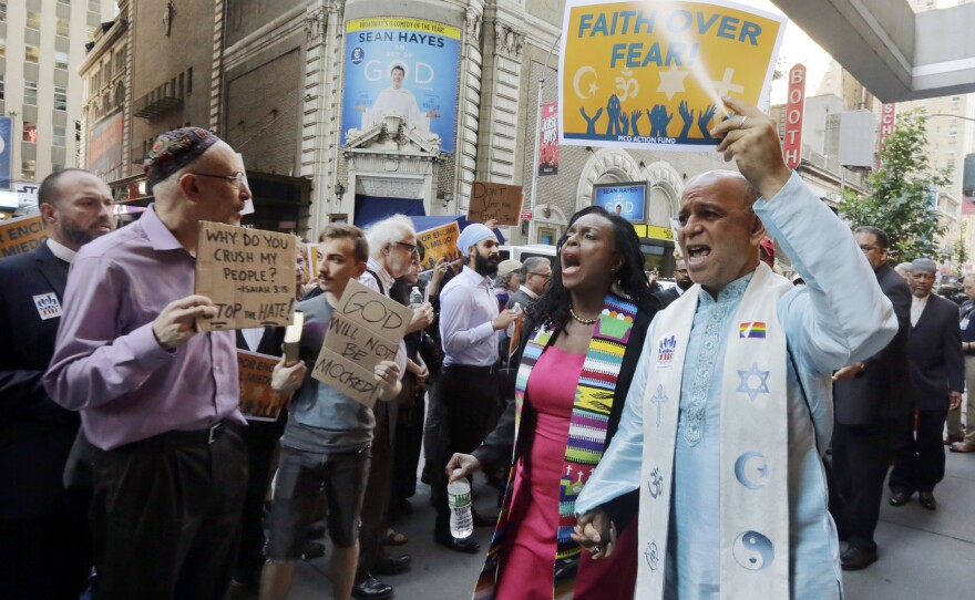 Clergy leaders demonstrated outside the hotel in New York's Times Square where Donald Trump met with evangelical clergy Tuesday.