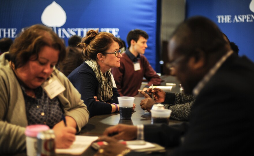 Reporters (left) interview the Aspen fellows during the session.