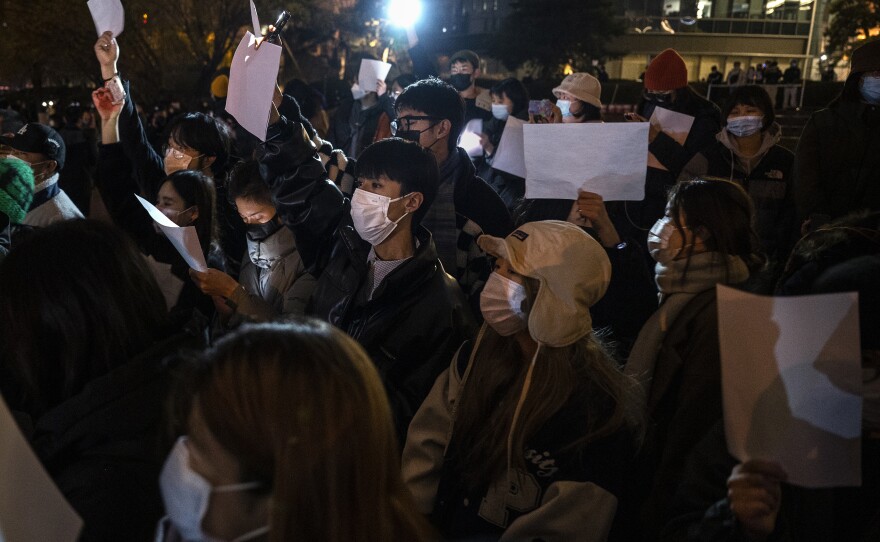Protesters hold up a white piece of paper against censorship during a protest against China's strict zero COVID measures on November 27, 2022 in Beijing.