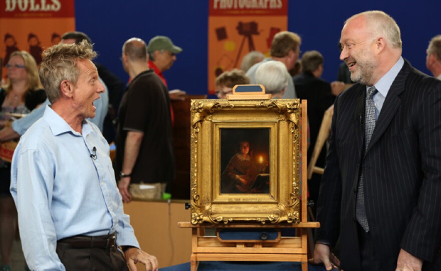 Alasdair Nichol (right) appraises a Petrus van Schendel oil painting, ca. 1860, for $20,000 to $40,000 in Detroit, Michigan.
