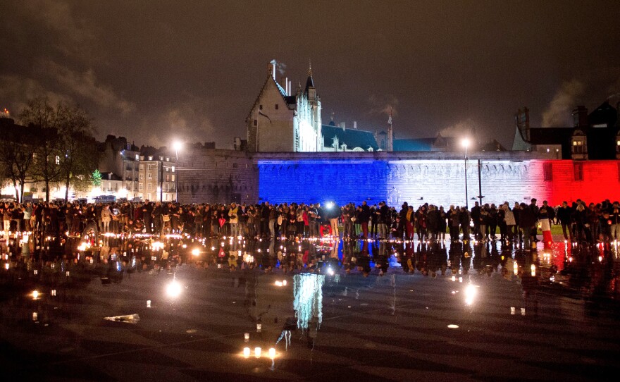 French citizens hold candles Friday on the esplanade in Nantes, western France, to pay tribute to the victims of the attacks of Nov. 13.