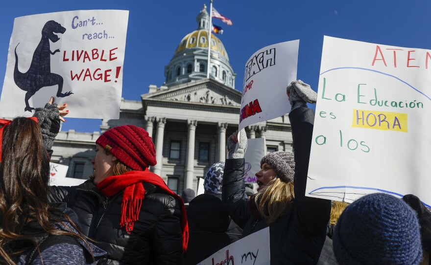 Teachers from Castro Elementary School cheer at a rally at the Colorado State Capitol on Monday.