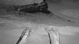 NASA's Mars Exploration Rover Opportunity climbed out of "Victoria Crater" following the tracks it had made when it descended into the 800-meter-diameter bowl nearly a year earlier.