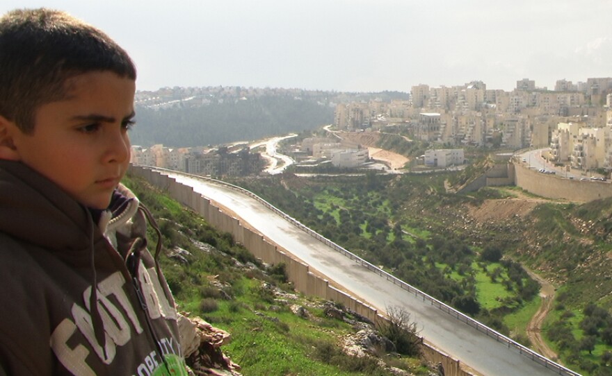 Emad Burnat's son Gibreel and the wall.