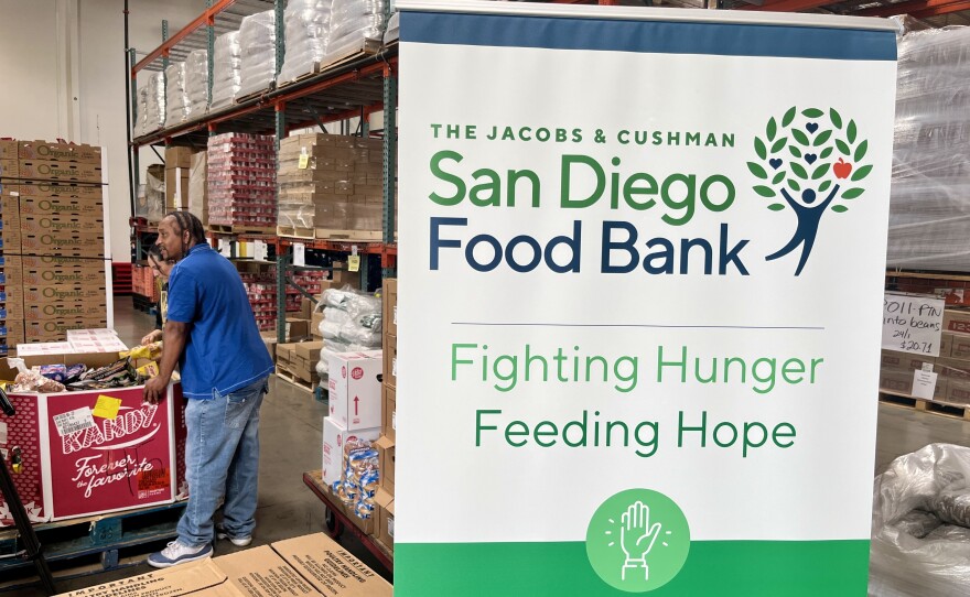 People load up boxes of donated food from the San Diego Food Bank's Miramar headquarters, July 15, 2025.