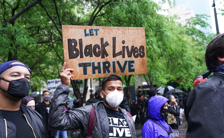 A protester holds a handmade sign in downtown Seattle on May 30.
