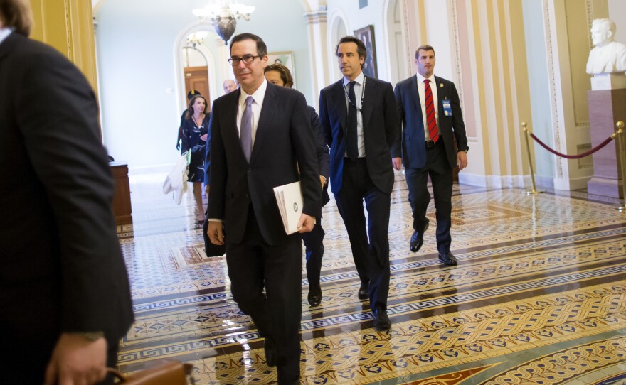 Treasury Secretary Steve Mnuchin (center) arrives Tuesday at a meeting with congressional leaders to discuss a tax overhaul.