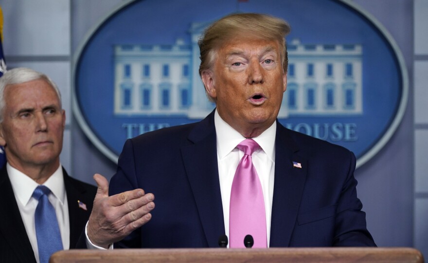 President Trump speaks as Vice President Pence listens during a Wednesday news conference about the U.S. response to the new coronavirus.