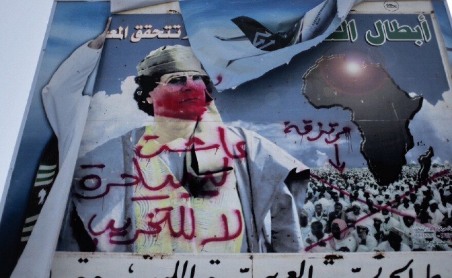 A vandalized billboard of Gadhafi stands outside the airport of the eastern city of Benghazi.