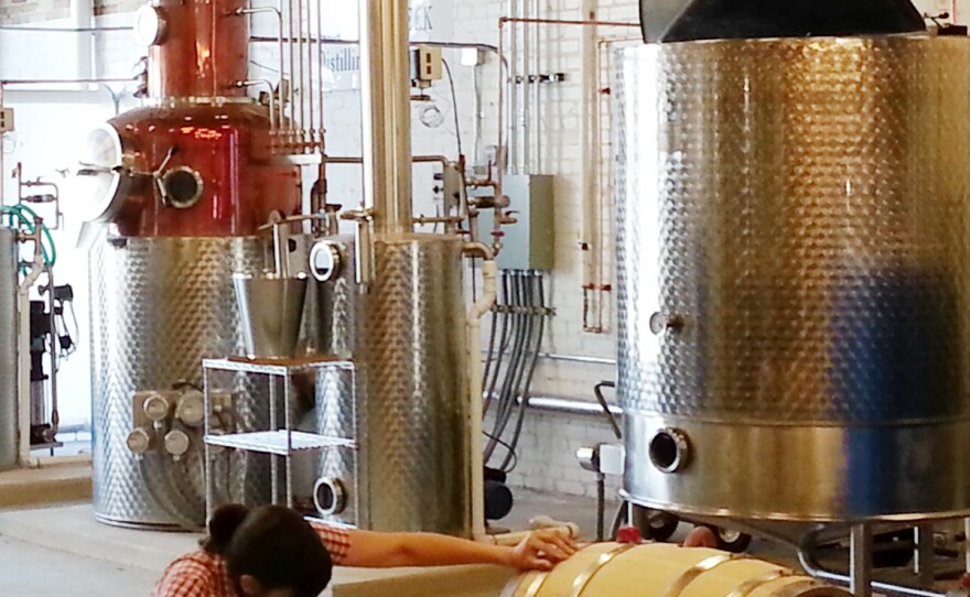 The potstills and mash tun at Catoctin Creek Distillery in Old Town Purcellville, Virginia. Rebecca Harris, founder of the distillery, checks a barrel for leaks.