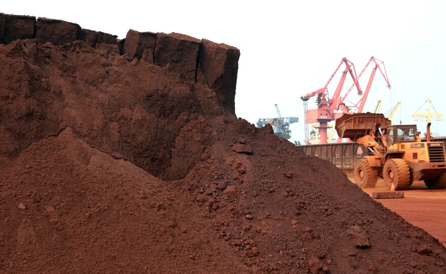 A worker in China shifts soil containing rare earth minerals intended for export in 2010. Rare earths are used in important technologies, and a commentary in China's People's Daily newspaper on Wednesday said the U.S. endangers its supply from China by waging a trade war.
