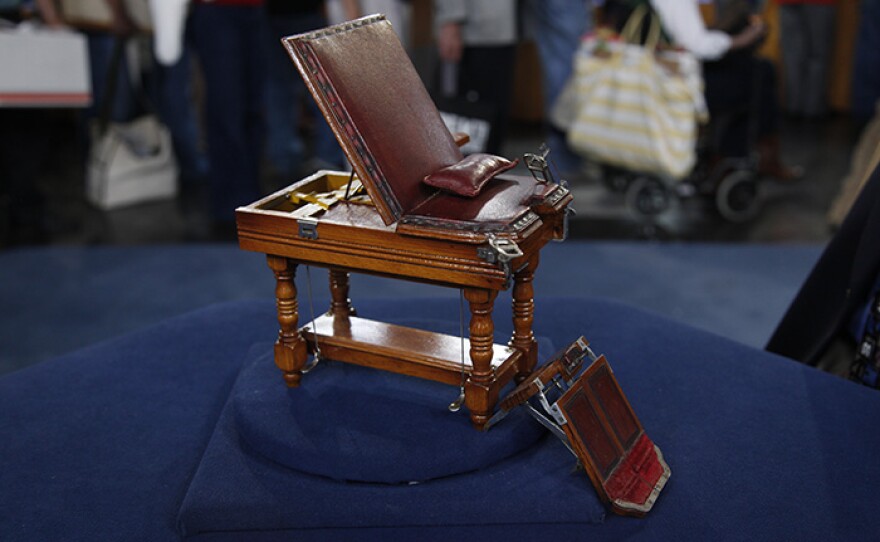 Noel Barrett (not pictured) appraises a salesman's sample operating chair, ca. 1890, in San Diego, Calif.