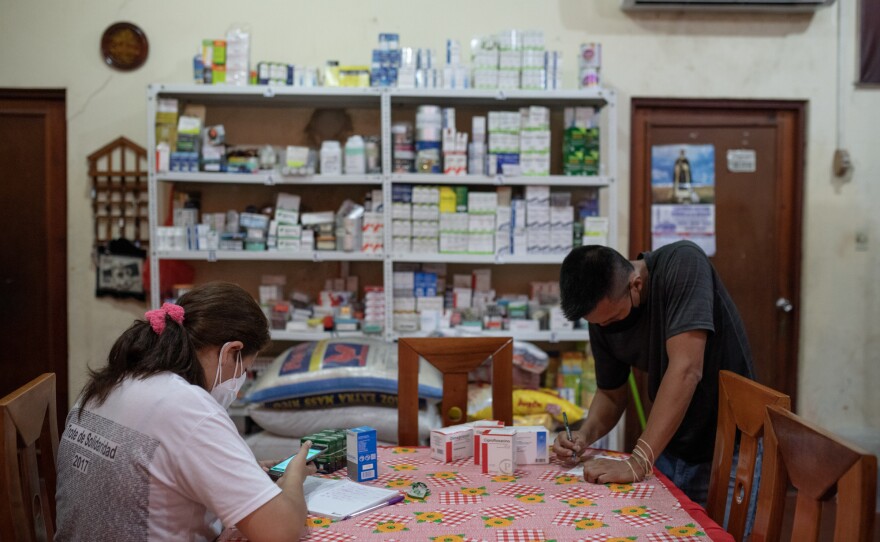 Volunteers sort medicines that are distributed free of charge at a medical clinic in the San Martin de Porres church in Iquitos, Peru. The pastor of the church was instrumental in bringing in a desperately-needed oxygen plant to the city in the worst days of the COVID pandemic.