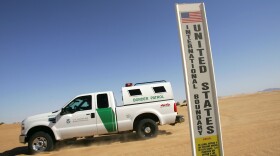 A border patrol vehicle passes an international border marker in the Colorado Desert at the Imperial Sand Dunes, also known as the Algodones Dunes, along the U.S.-Mexico border on April 5, 2008 between El Centro, California and Yuma, Arizona.