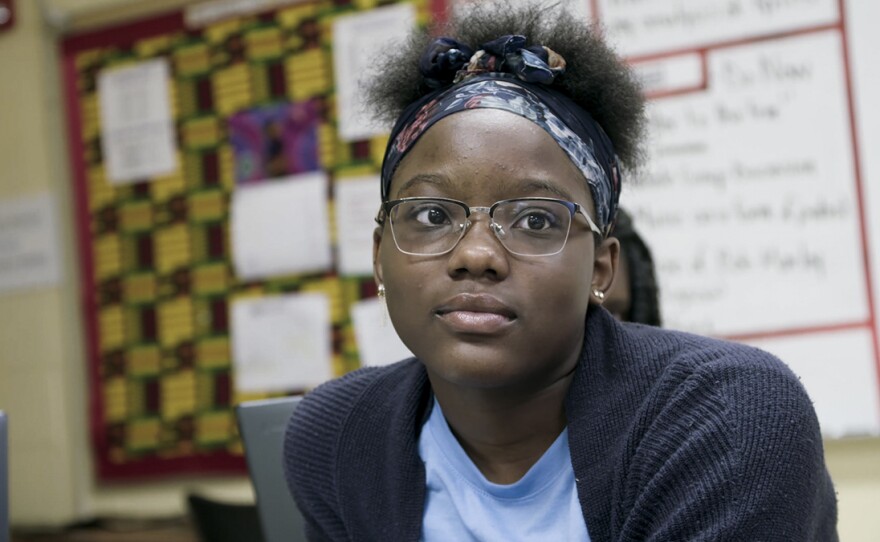A student sits in a classroom.