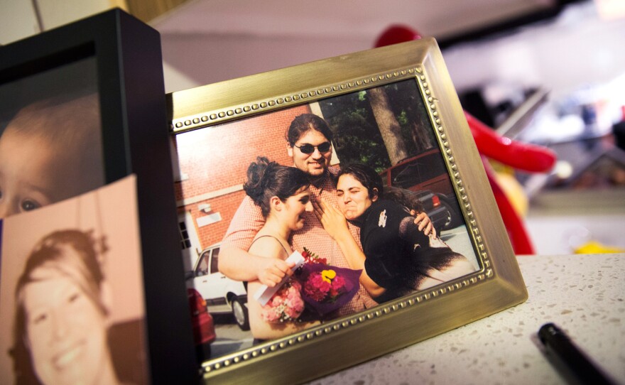 A photograph of Carlos Romero with his sisters in high school sits on the counter in Romero's apartment in Seattle.