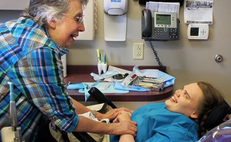 Sandra Klecker sings to her daughter Lindsay to help her stay calm through the cleaning.