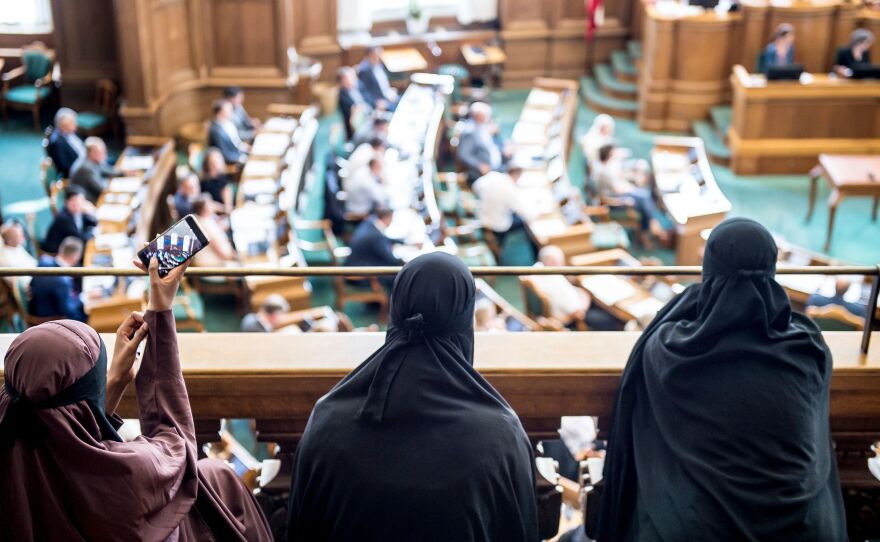 Women wearing the niqab sit in the audience at the Danish Parliament in Copenhagen on Thursday, as a bill that bans face coverings in public passes by a majority vote.