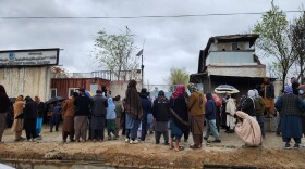 A crowd gathers outside Kabul's Omid Addiction Treatment Hospital, where the United Nations says an airstrike killed more than 100 people on March 16.
