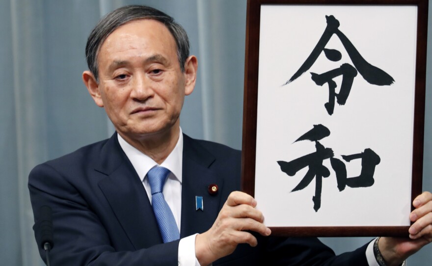 Japan's Chief Cabinet Secretary Yoshihide Suga unveils the name of new era "Reiwa" on Monday. The new era starts May 1, when Crown Prince Naruhito takes the throne from his father.