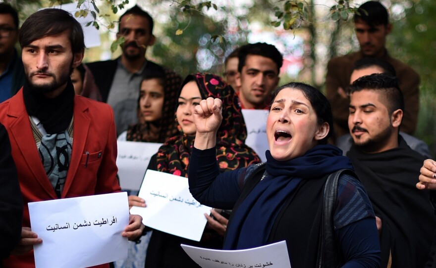 Activists protest in Kabul against Taliban militants who stoned an Afghan woman to death after accusing her of adultery.