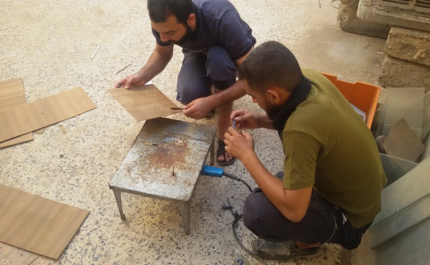 Two of Mokdad's cousins help him build his new instrument, which he named "Adad."