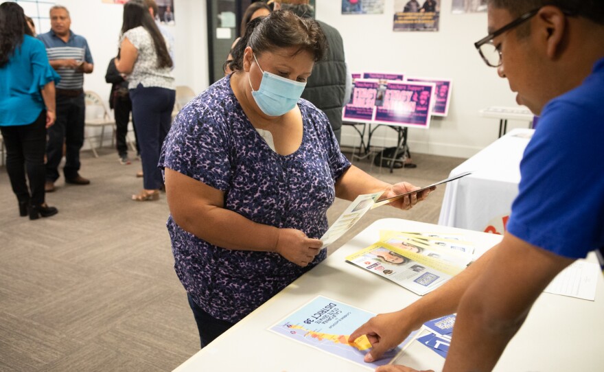 Ariam Díaz asks questions about the upcoming election at the Universidad Popular election education fair in San Marcos, Oct. 20, 2022.