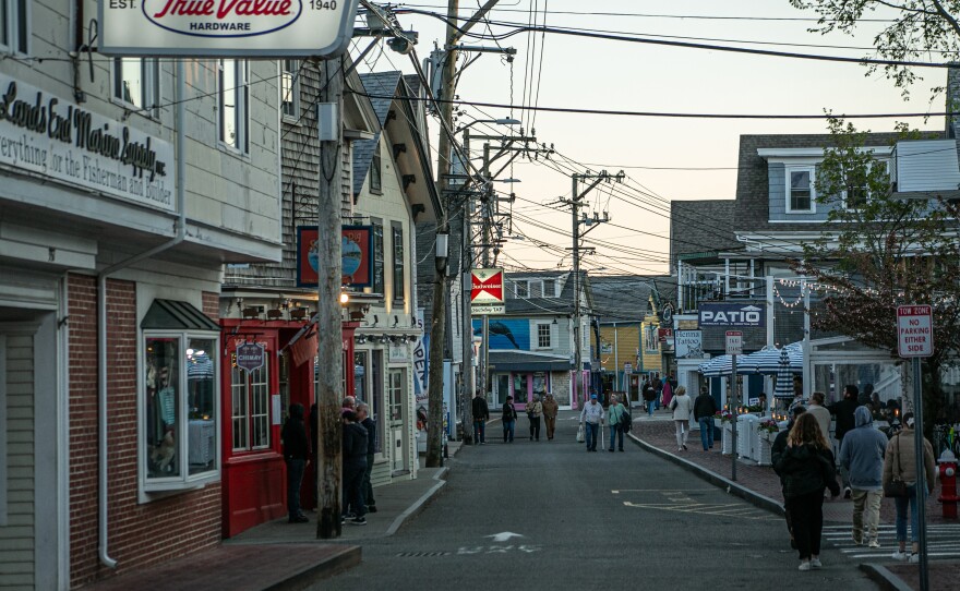 People walk down Commercial Street in Provincetown. The city balloons from 3,500 residents to 60,000 when tourists visit in the summer.