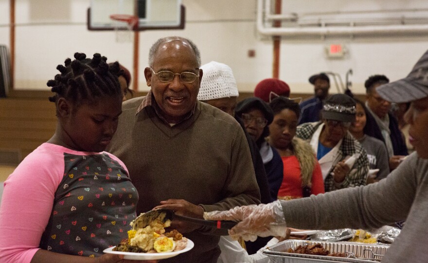 Harold Valentine (center), a local resident, attends a community Thanksgiving meal at Kennedy Recreation Center in Shaw.