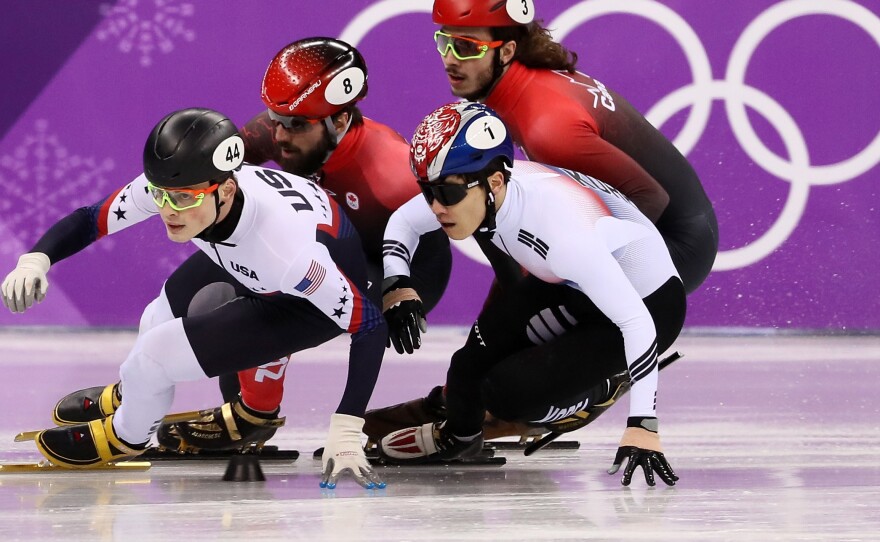 John-Henry Krueger of the United States (left), Yira Seo of Korea, Charles Hamelin of Canada and Samuel Girard of Canada compete in the short track 1,000-meter semifinals on Feb. 17. Krueger won silver.