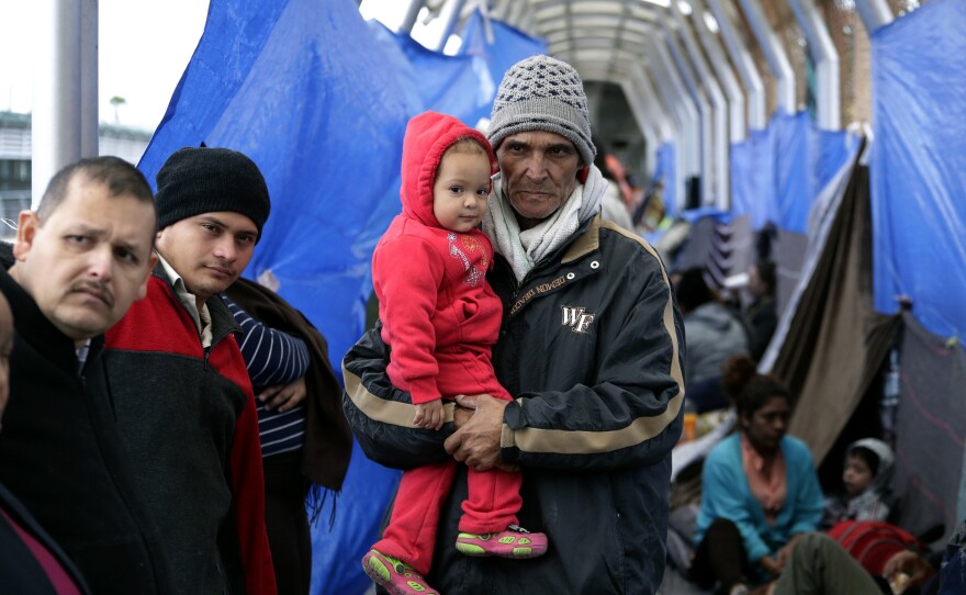 Families hoping to seek asylum in the United States wait on the bridge connecting Reynosa, Mexico, to Hidalgo, Texas. At the current pace, the federal government says, almost 100,000 migrants will cross the border this month.