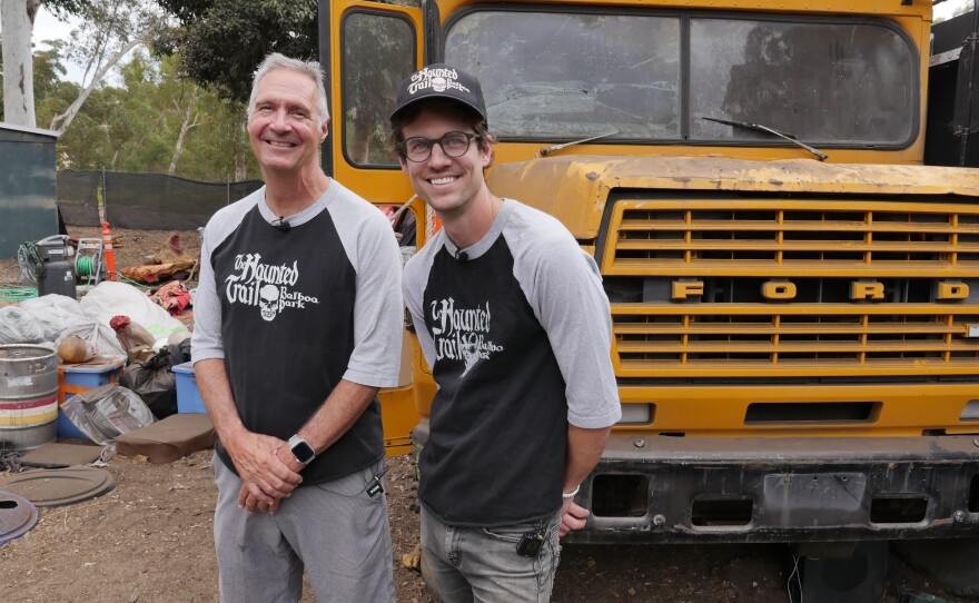 Greg DeFatta and his son Dylan in front of The Haunted Trail's iconic school bus that will be making an appearance at this year's haunted attraction in Balboa Park.