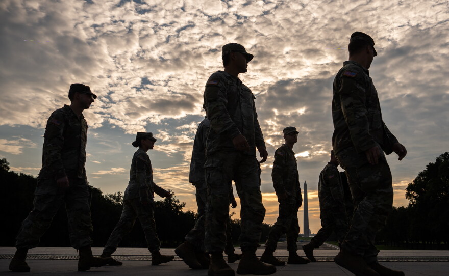 Members of the National Guard walk past the Lincoln Memorial Reflecting Pool before the March on Washington, Friday, Aug. 28, 2026, in Washington.