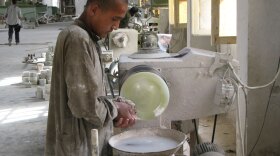 A worker shapes an onyx plate at an Afghan stone-cutting factory. The plant -- in a part of Helmand province once known as "Little America" -- tripled its workforce after American workers upgraded a nearby hydroelectric dam.