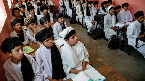 Afghan school boys wear Taliban-imposed uniforms of turbans and long tunics in a school in Herat. The government has put more focus on religious education since returning to power on August 15, 2021.
