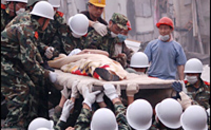 Soldiers carry out Liu Deyun, who had been trapped in a fertilizer factory since Monday's earthquake.