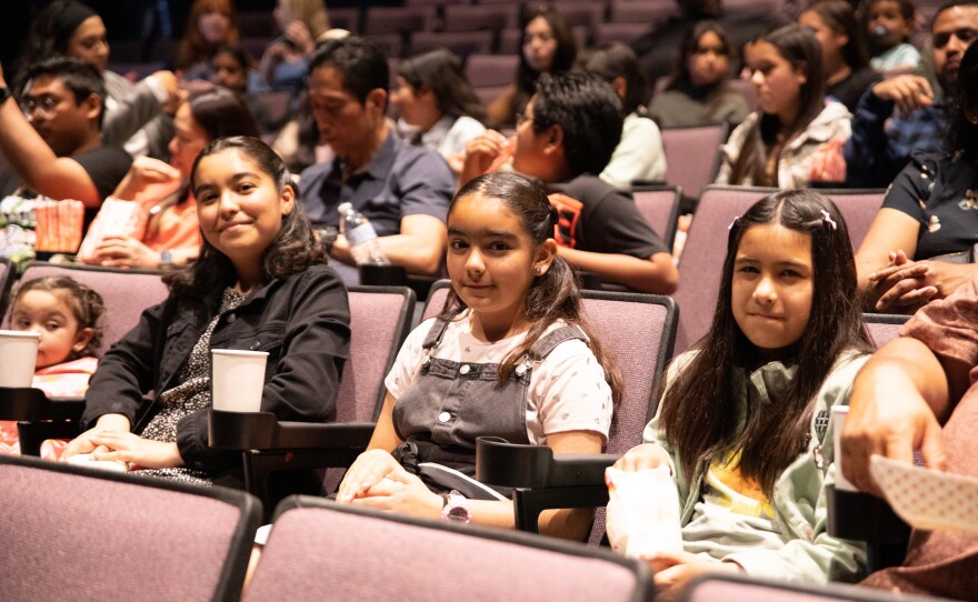 Young students and their families sit inside a theater during 2023's first annual Elementary School Animation Film Festival in this undated image.