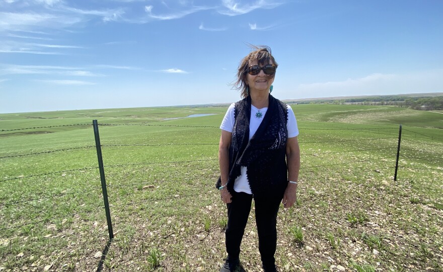 Pauline Sharp standing on a hilltop on the tribe's property in the Flint Hills, where they are considering placing the rock.
