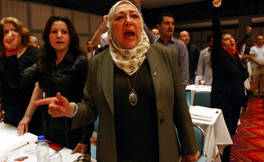 Syrian opposition activists chant in Antalya, Turkey, during the opening session of a three-day meeting to discuss democratic change and voice support for the revolt against President Assad's regime.